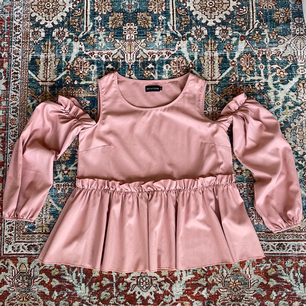Silky blush blouse with ruffle details and shoulder cutouts